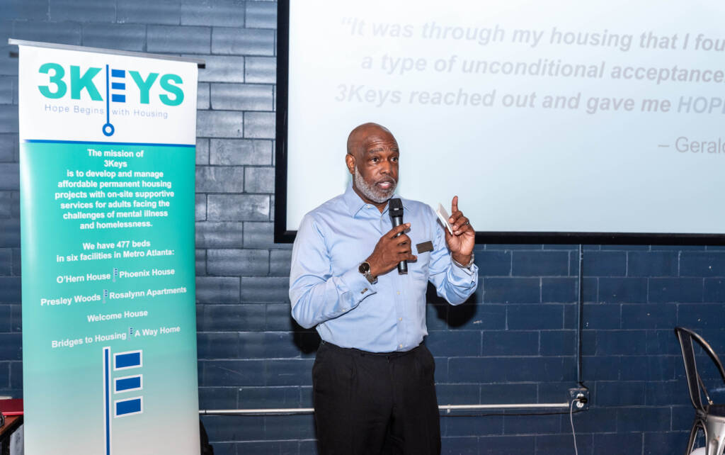 Scott Walker, President and CEO of The 3Keys, speaks to Breakthrough Atlanta supporters gathered for its Cheers for a Cause fundraiser for affordable housing in Atlanta