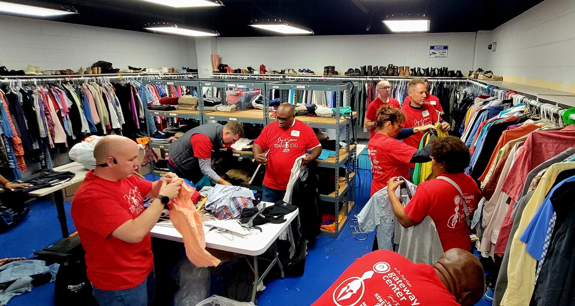 Titan 100 Day of Service at the Gateway Center with volunteers sorting clothing for individuals experiencing homeless