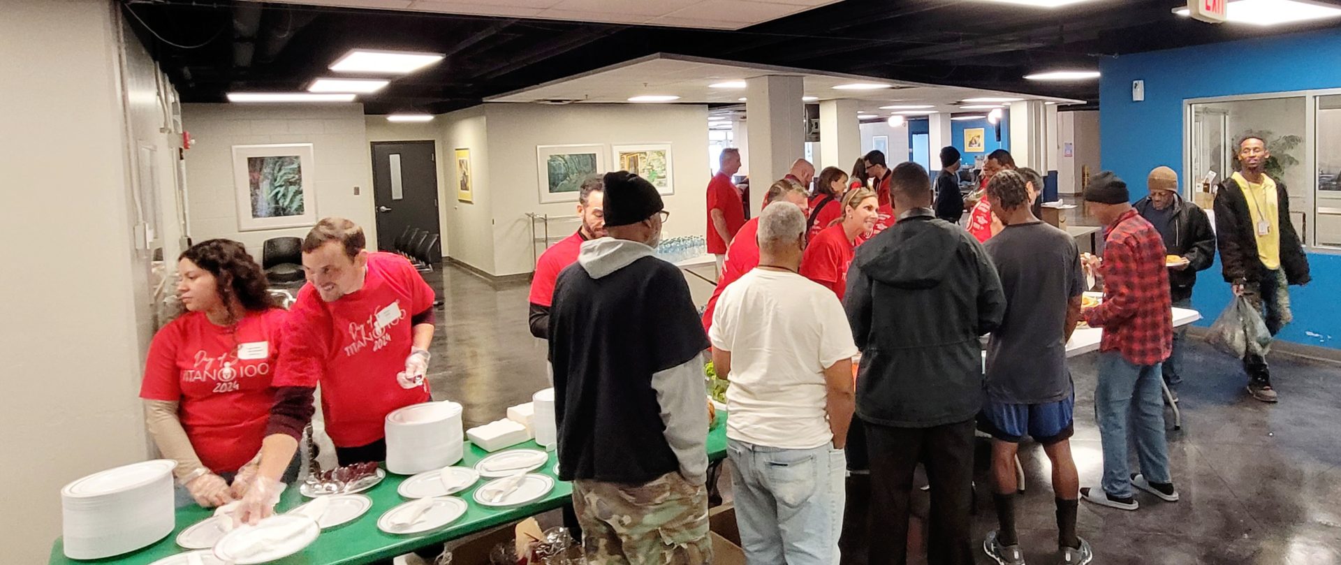 Titan 100 Day of Service at the Gateway Center with volunteers serving meals for individuals experiencing homeless